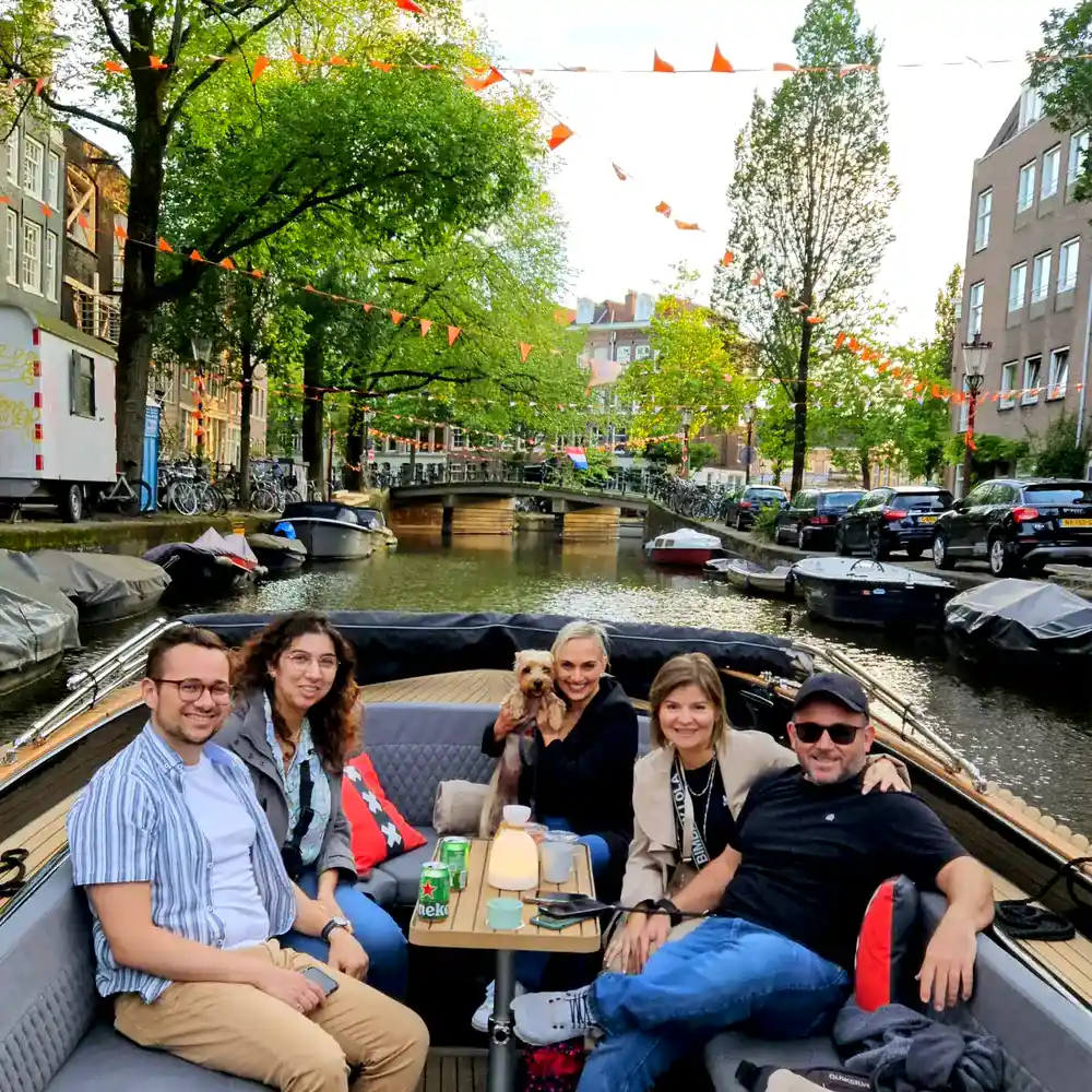 guests enjoying boat tour in Amsterdam with their dog